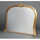 A Victorian arched shaped over mantel mirror contained in a decorative gilt plaster painted frame