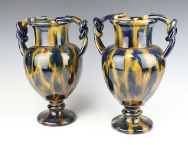 A pair of 19th Century continental pottery twin handled vases 31cm One is extensively stuck