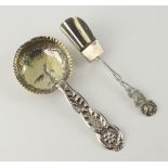 A repousse silver gilt strainer spoon, together with a ditto sugar shovel, 37 grams