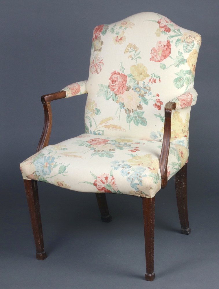 A 19th Century mahogany open arm library chair, the seat and back upholstered in floral material