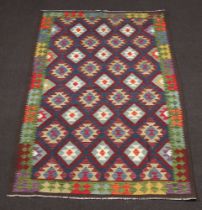 A brown, black and green ground Maimana Kilim rug with diamond design 252cm x 161cm