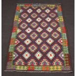 A brown, black and green ground Maimana Kilim rug with diamond design 252cm x 161cm
