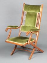 An Edwardian mahogany folding campaign chair upholstered in green material 109cm x 63cm x 61cm (seat