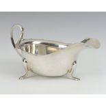 A Georgian style silver sauce boat with S scroll handle on pad feet Sheffield 1932 15cm, 102 grams