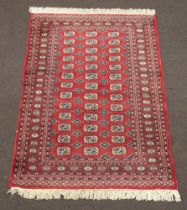 A red and blue ground Bokhara carpet with 39 octagons to the centre 188cm x 127cm, light moth