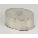 An oval white metal 19th Century engraved tobacco box with a crest 8.5cm, 105 grams