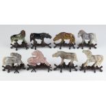 A set of 8 Chinese carved hardstone figures of horses raised on hardwood stands 7cm The right facing