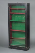 A Victorian ebonised display cabinet, fitted shelves enclosed by a glazed panelled door 178 cm h x