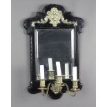 A 19th Century rectangular plate mirror contained in an ebonised and gilt mounted frame, the base