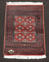 A pink ground Persian carpet, the rectangular central medallion with 6 stylised medallions to the