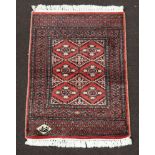 A pink ground Persian carpet, the rectangular central medallion with 6 stylised medallions to the