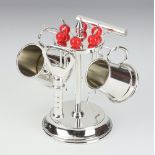 An Art Deco silver plated cocktail set comprising 2 miniature mugs, 6 cocktail sticks, a corkscrew