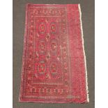 A section of blue and red ground Bokhara rug 176cm x 87cm In wear