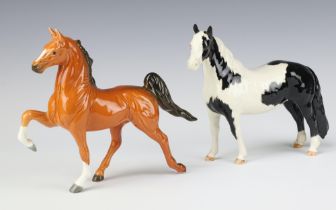 A Beswick figure of a prancing light bay horse 16cm and 1 other Pinto Pony No 1373 piebald gloss
