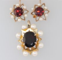 A 9ct yellow gold garnet and pearl pendant 25mm together with a pair of similar ear studs (1 pearl