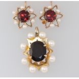 A 9ct yellow gold garnet and pearl pendant 25mm together with a pair of similar ear studs (1 pearl