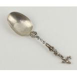 A 19th Century Continental silver dessert spoon with figural terminal 57 grams, 19cm
