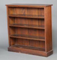 A Victorian oak open bookcase fitted adjustable shelves raised on a platform base 111cm h x 107cm