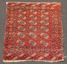 A red and white blue ground Bokhara rug with 18 octagons to the centre 130cm x 110cm In wear