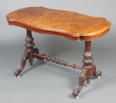 A Victorian figured walnut stretcher table of serpentine outline, raised on bulbous turned