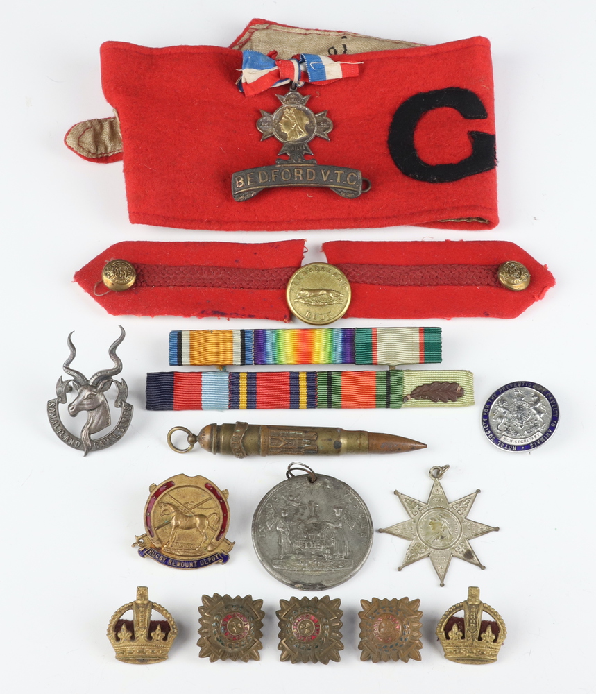 A Somaliland Camel Corps cap badge, 2 General Staff red epaulettes, medal ribbons etc