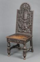 A 19th Century Continental deeply carved oak hall chair, the back carved a cross with challis