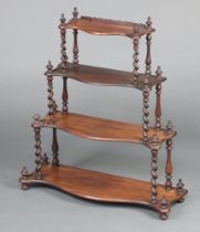 A Victorian rosewood 3 tier hanging wall shelf of serpentine outline, raised on spiral turned