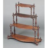 A Victorian rosewood 3 tier hanging wall shelf of serpentine outline, raised on spiral turned