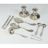 A pair of dwarf silver candlesticks Birmingham 1966 8cm, 2 pairs of sugar nips and 5 spoons