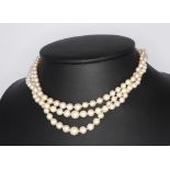 A triple strand of cultured pearls with a white metal diamond clasp 34cm This lot has an approximate