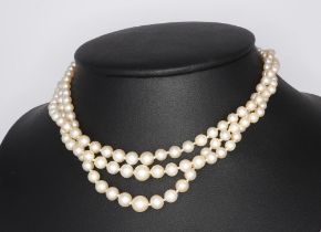 A triple strand of cultured pearls with a white metal diamond clasp 34cm This lot has an approximate