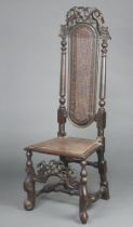 A 17th/18th Century carved walnut high back chair, the pierced and cast cresting rail decorated