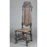 A 17th/18th Century carved walnut high back chair, the pierced and cast cresting rail decorated