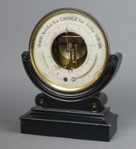 A 19th Century aneroid barometer with silvered dial contained in a gilt metal circular case raised