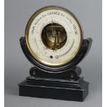 A 19th Century aneroid barometer with silvered dial contained in a gilt metal circular case raised