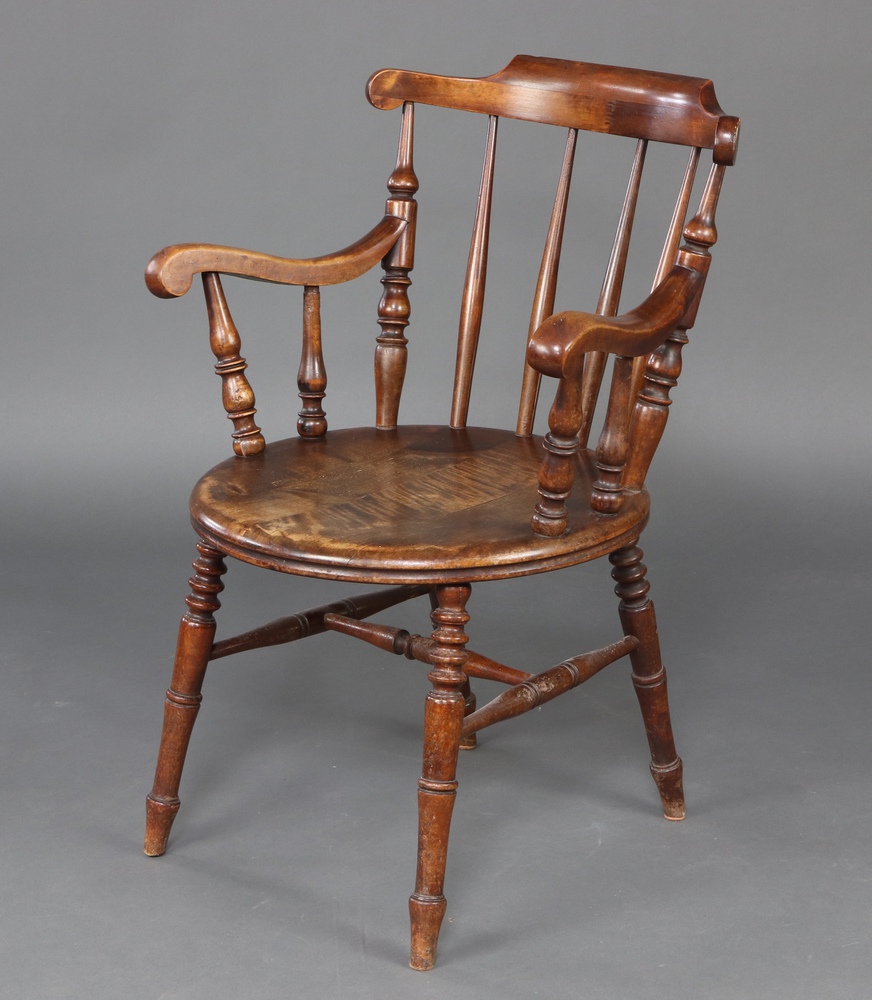 A 19th Century beech stick and rail back Windsor carver chair raised on turned supports with H