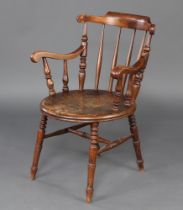 A 19th Century beech stick and rail back Windsor carver chair raised on turned supports with H