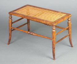 A Victorian rectangular bleached mahogany stool with woven cane seat, raised on turned supports 43cm