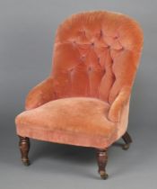 A Victorian metal framed tub back chair upholstered in pink material, raised on turned supports 78cm
