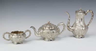 A fine 19th Century Chinese white metal repousse tea set comprising teapot, coffee pot and sugar