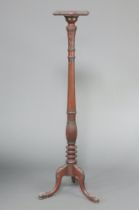 A William IV turned and fluted mahogany torchere with square top, raised on a platform base 152cm