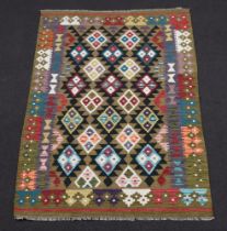 A black and green ground Maimana Kilim rug with all over diamond design 193cm x 129cm