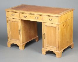 A 19th Century pine desk with brown inset leather writing surface, the frieze fitted 1 long and 2