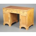 A 19th Century pine desk with brown inset leather writing surface, the frieze fitted 1 long and 2