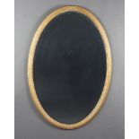 A 19th Century oval bevelled plate wall mirror contained a ribbon and reeded ball studded gilt frame