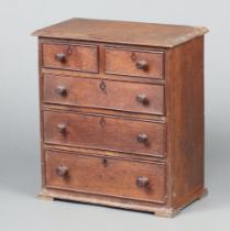 A 19th Century oak pedestal chest of 2 short and 3 long drawers with inlaid faux escutcheons