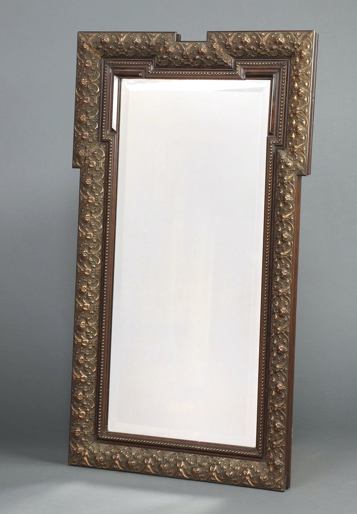 A 19th Century rectangular bevelled plate mirror contained in a decorative gilt frame 100cm h x 74cm