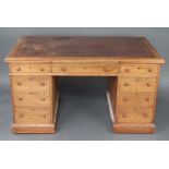 A Victorian light oak partners desk with inset brown leather writing surface and moulded edge,