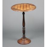A 19th Century circular inlaid mahogany chess table, raised on a turned column and circular