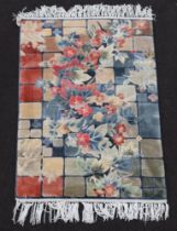 A Chinese silk floral patterned rug 92cm x 61cm